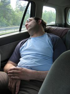 man sleeping in car
