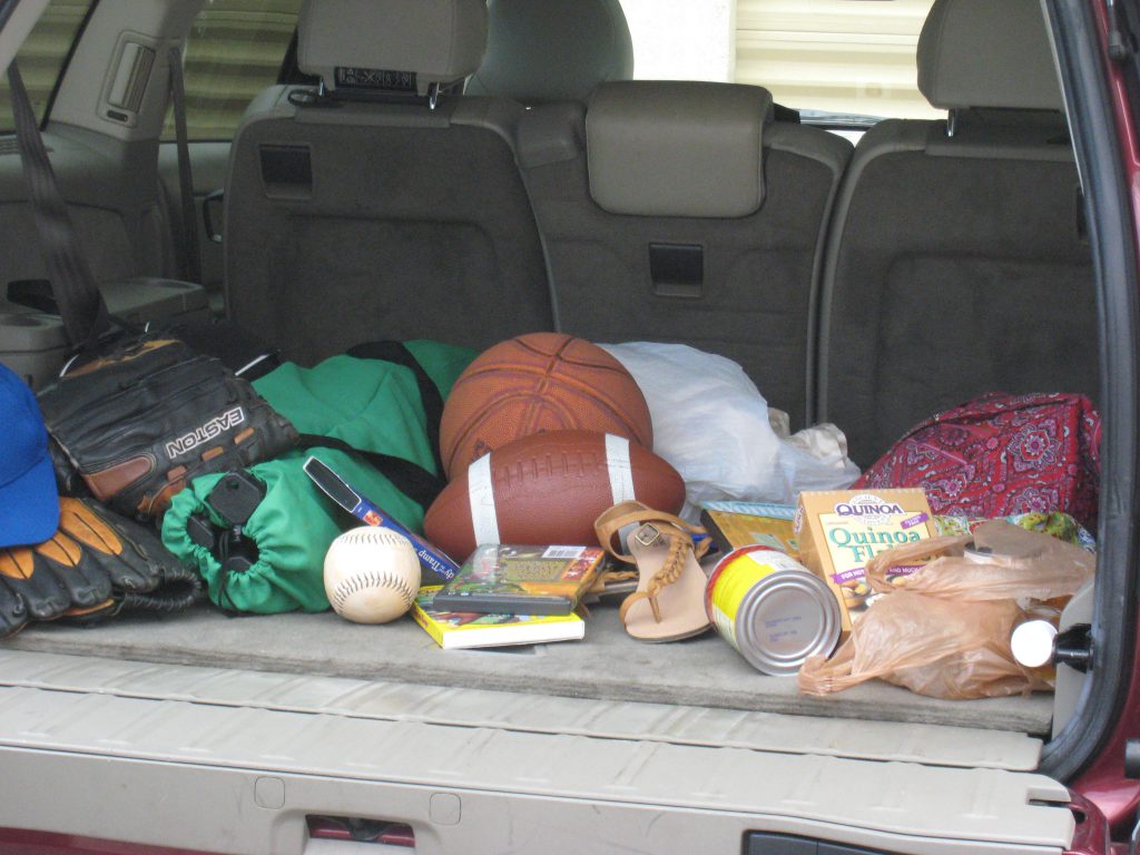 messy car with sports gear