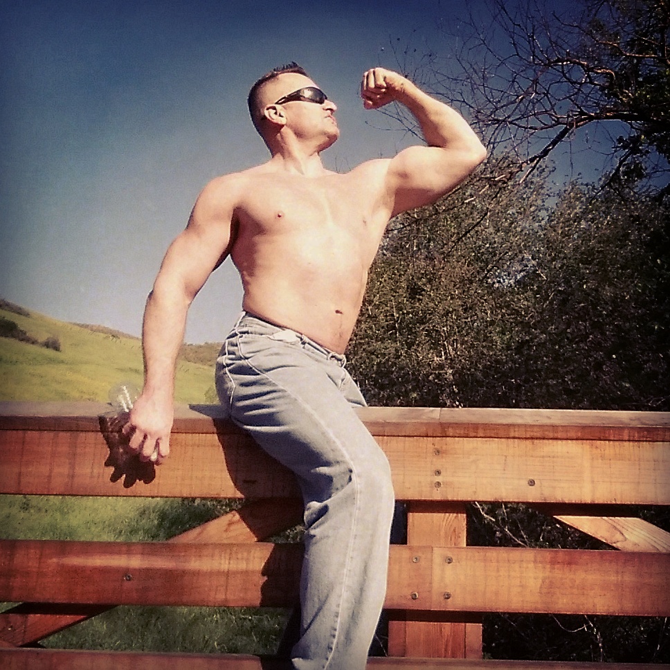 shirtless man flexing his muscle