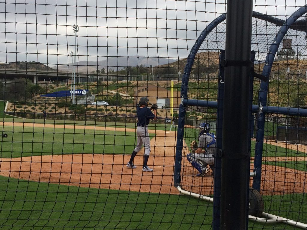 baseball player taking batting practice