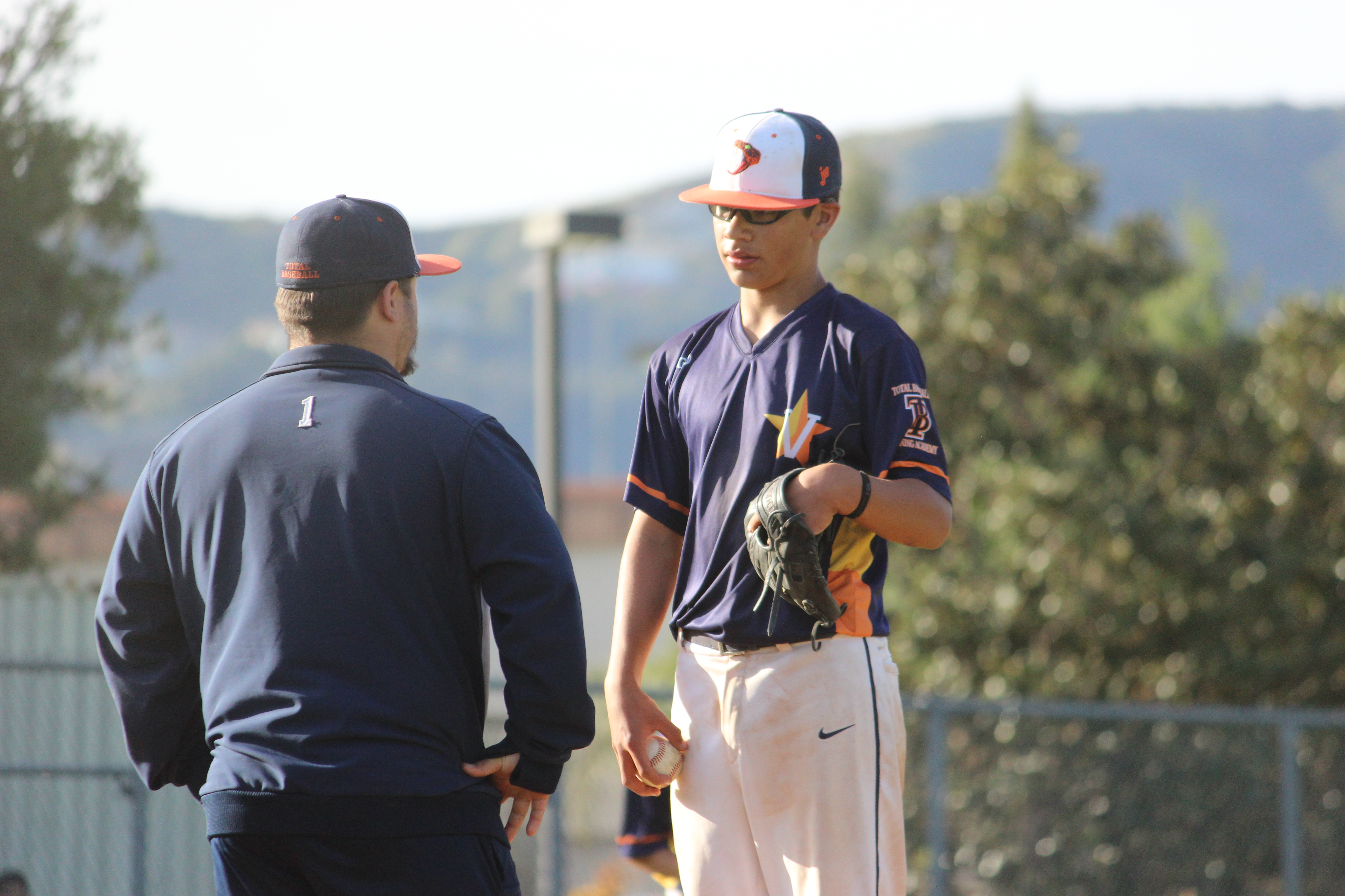 coach and taller baseball player