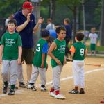 coach encouraging baseball team