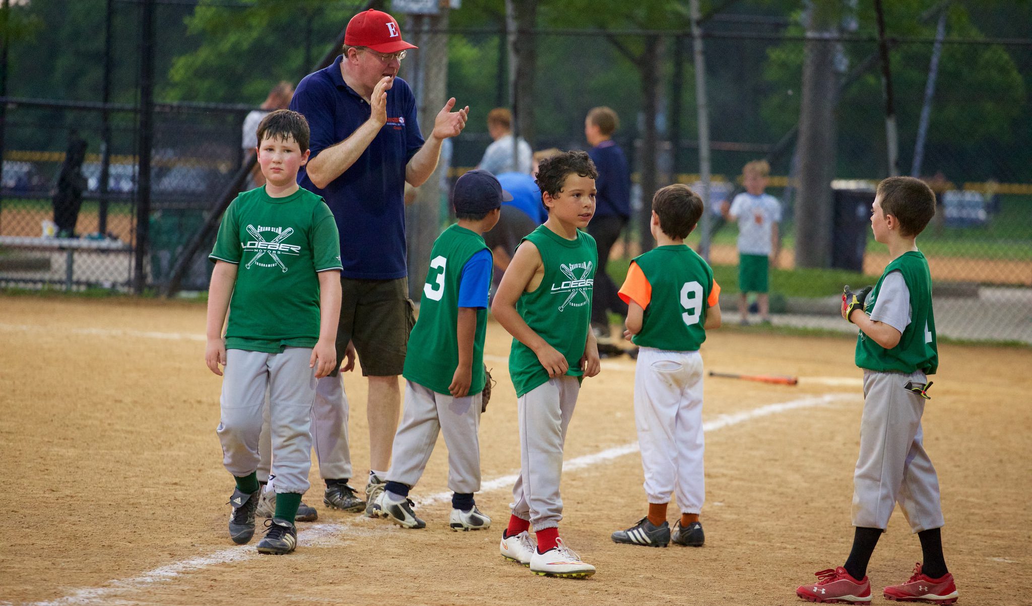 coach encouraging baseball team