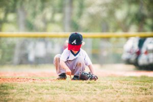 kid playing with grass during game