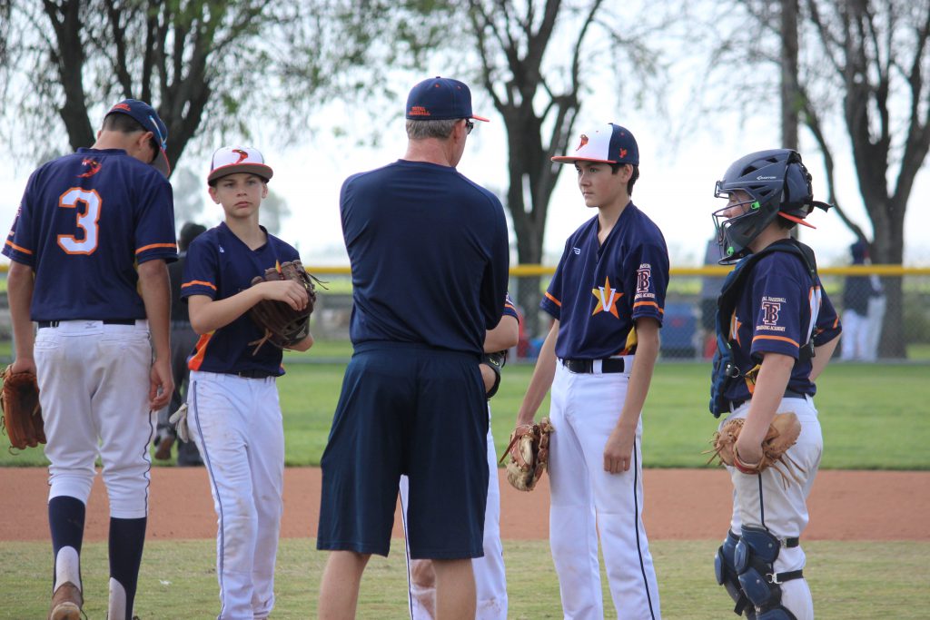 coach and players meeting at the mound