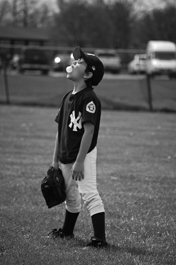 baseball kid blowing a bubble