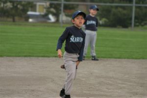 baseball kid with glove between legs