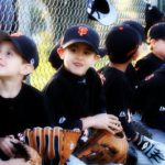 little baseball players in the dugout