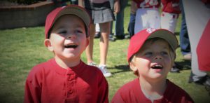 2 baseball kids in red uniforms