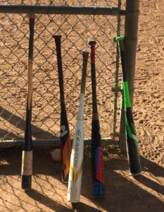 baseball bats against fence