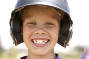 smiling boy in baseball helmet