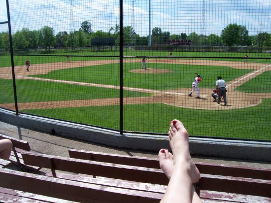 baseball fan with feet up