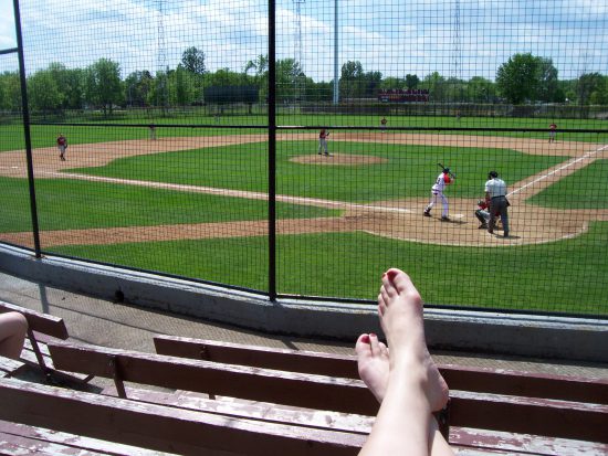 baseball fan with feet up