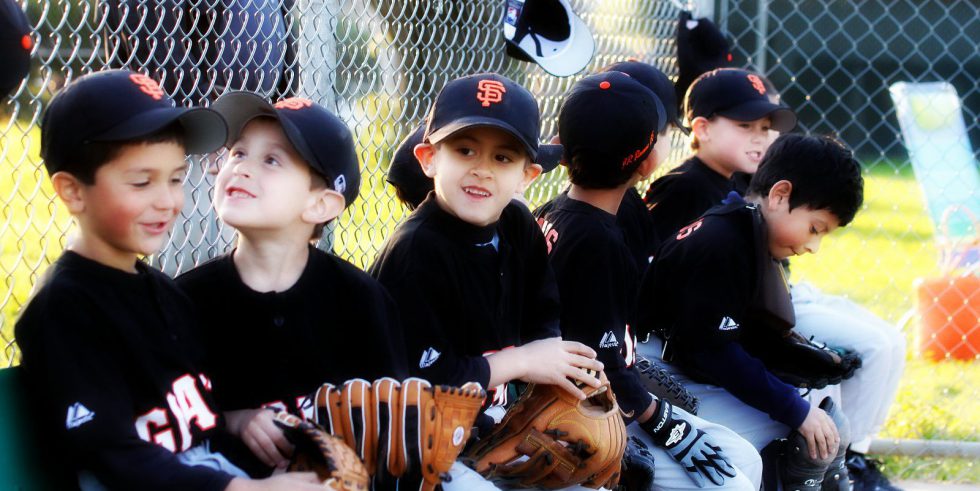 little baseball players in the dugout