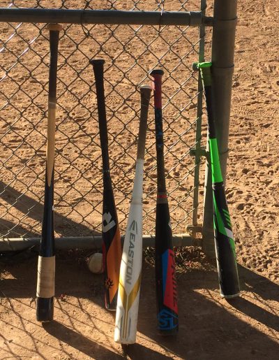 baseball bats against fence