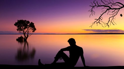 man watching sunset on the beach